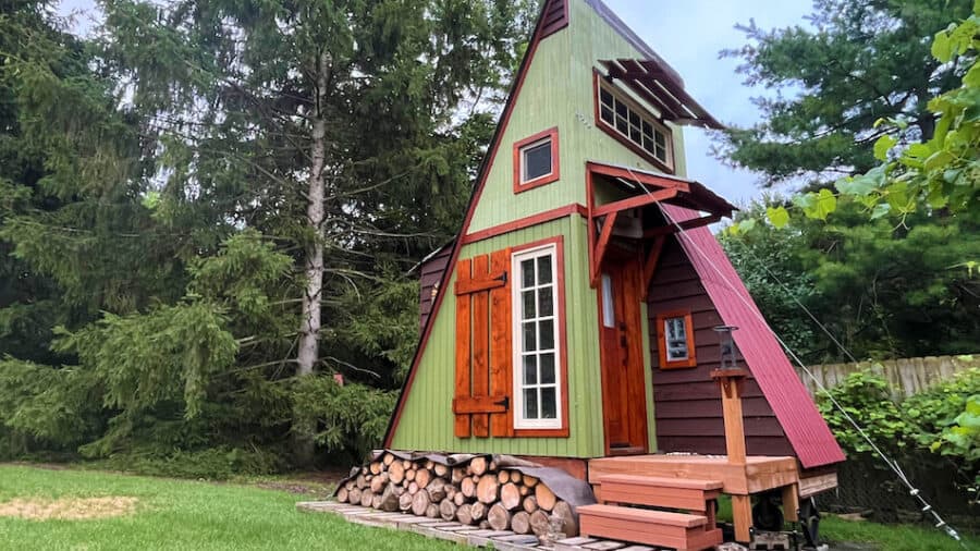 Off-grid tiny cabin with colorful exterior and wooden accents.