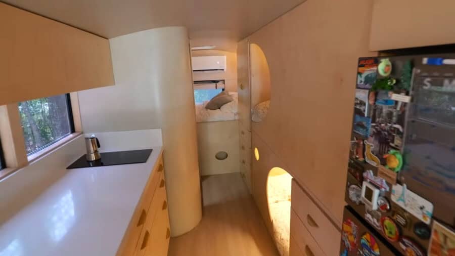 Interior of a tiny house with compact kitchen and creative design elements.