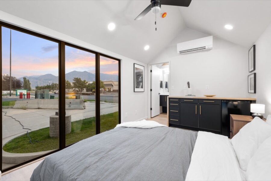 Compact tiny house interior with modern design and large windows.