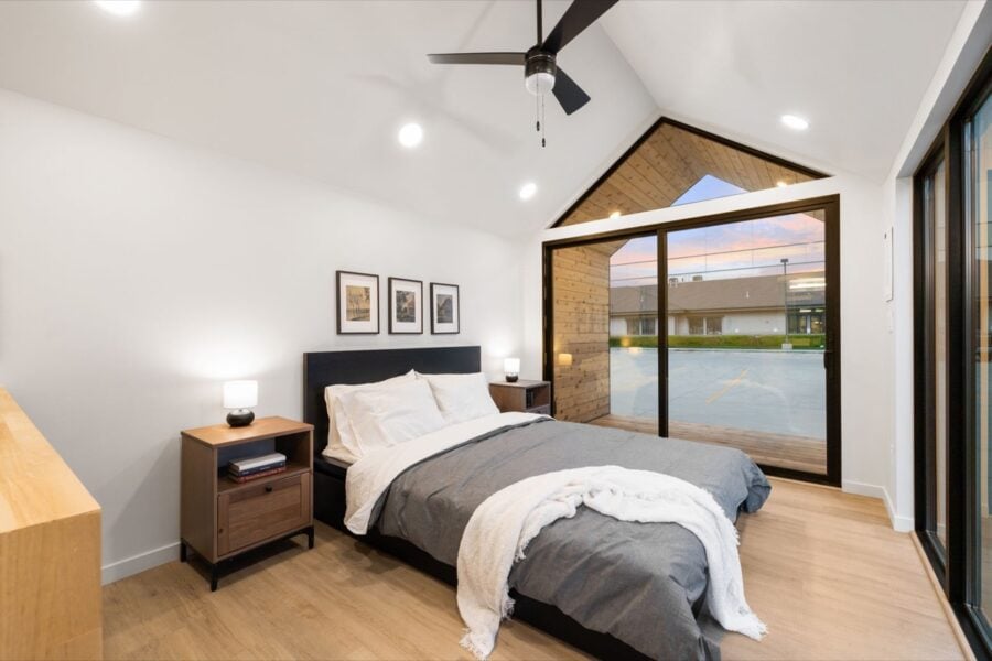 Cozy bedroom in Mysa 200 park model tiny house with modern design and large windows for natural ligh.