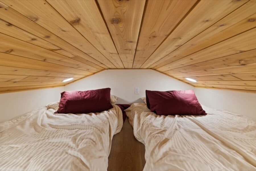 Cozy sleeping area in the Sledhaus 200 tiny house by Irontown Modular.