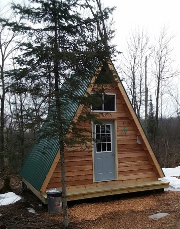 14×14 A-frame tiny cabin built using plans from Simple Solar Homesteading