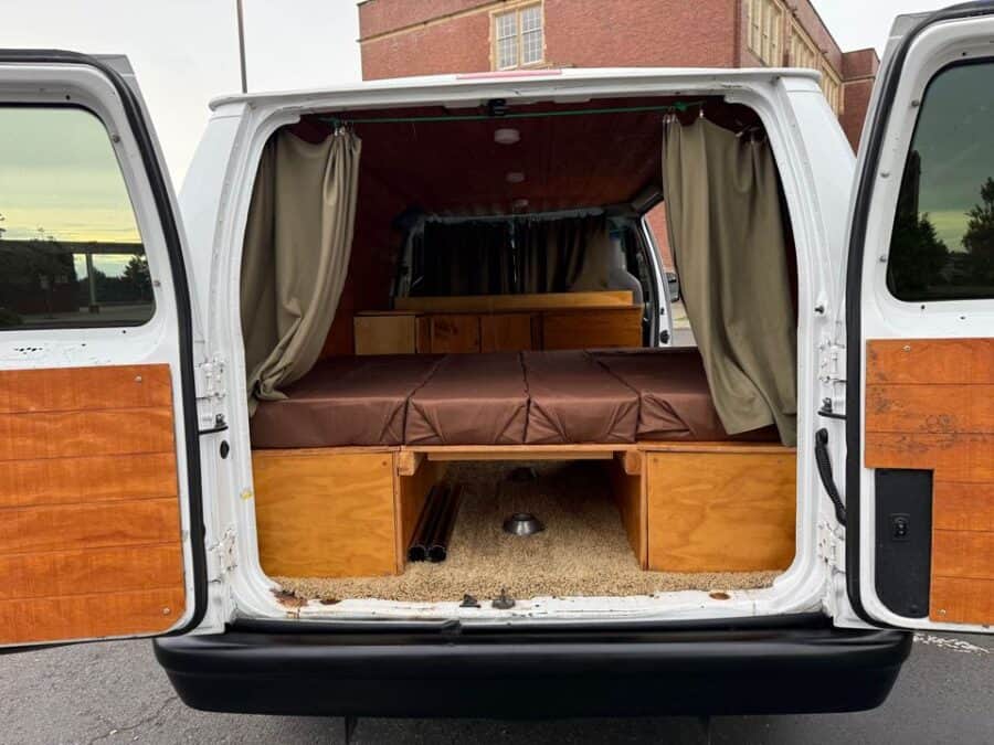 Ford E150 Campervan Interior with Custom Wooden Storage.
