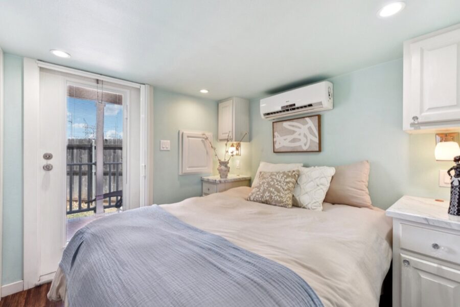 Interior view of a cozy tiny house bedroom near Austin with a large bed and modern decor.