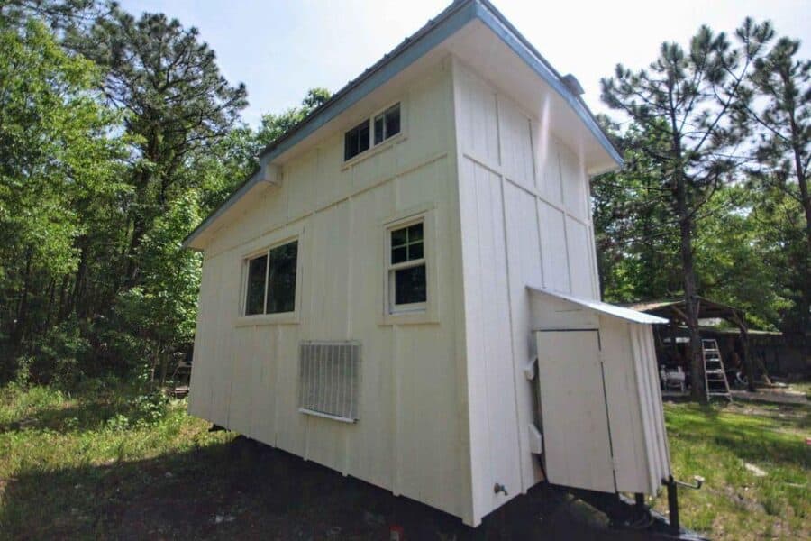 Compact 18-foot tiny house in Houston with white exterior and small windows.