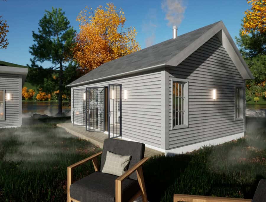 Small one-bedroom cottage with gray siding and large windows, perfect for tiny house living.