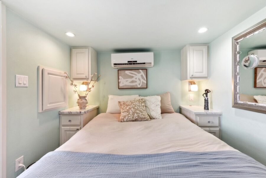 Comfortable tiny house bedroom with soft bedding and modern decor near Austin. Perfect for small spa.