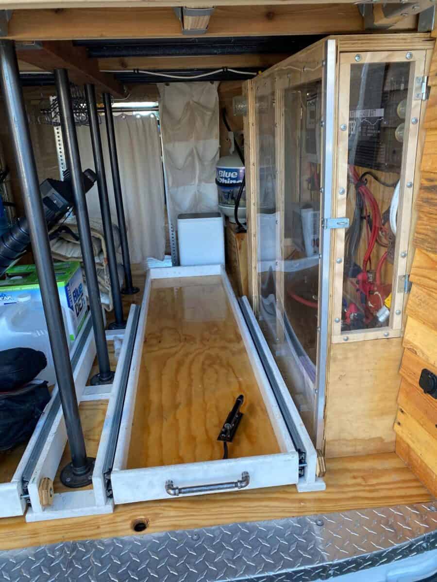 Efficient tiny house van conversion with custom features and space-saving design.