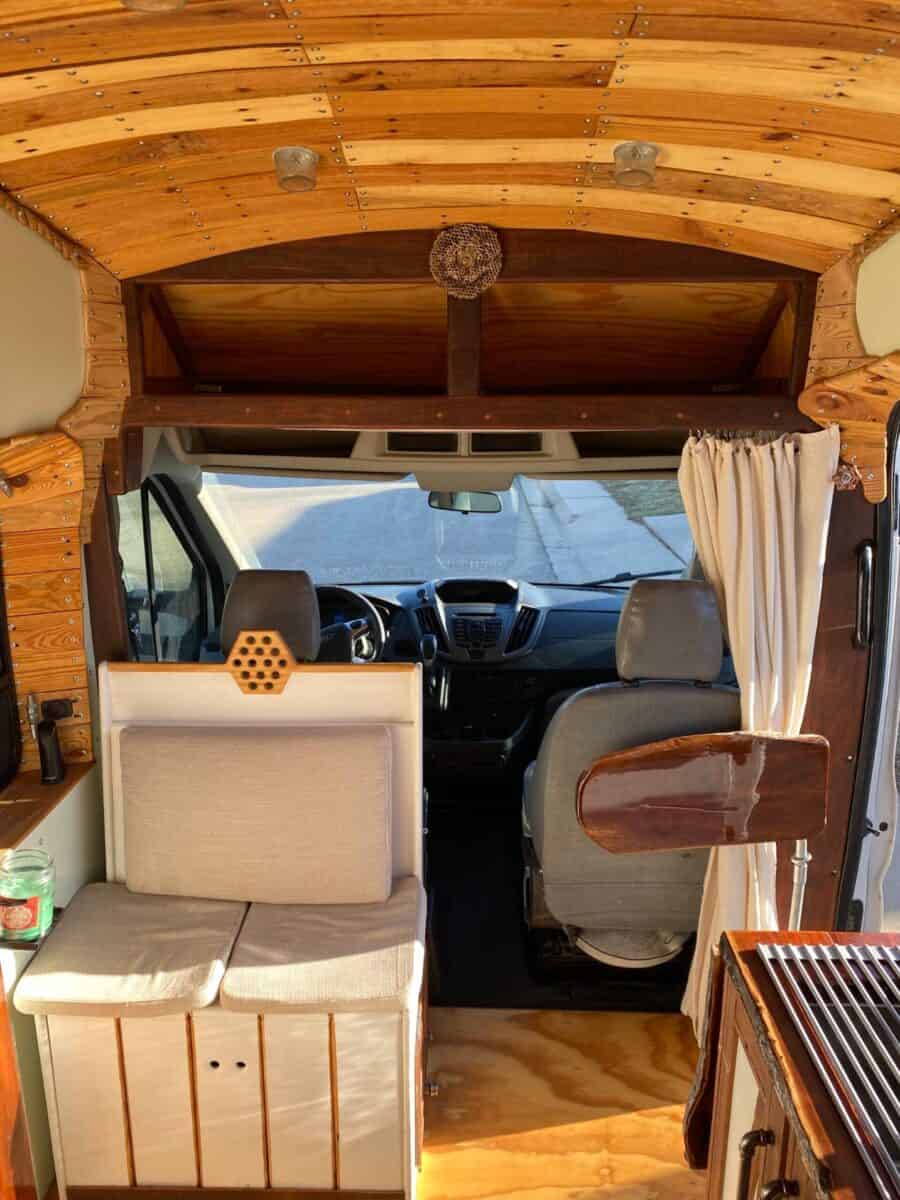 Van interior with wooden accents and compact living space.