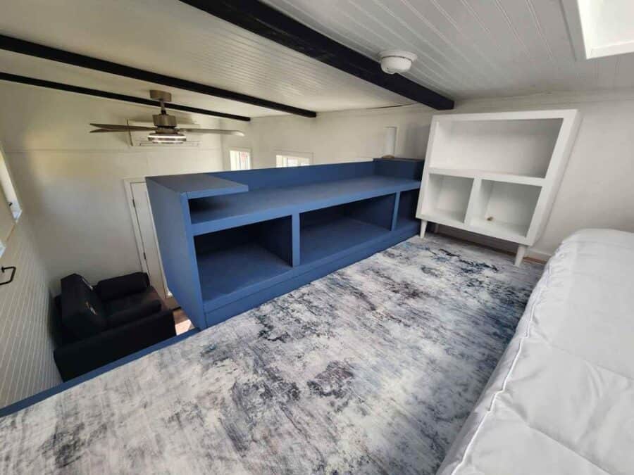 Custom blue storage shelf in a tiny home interior for efficient space use.