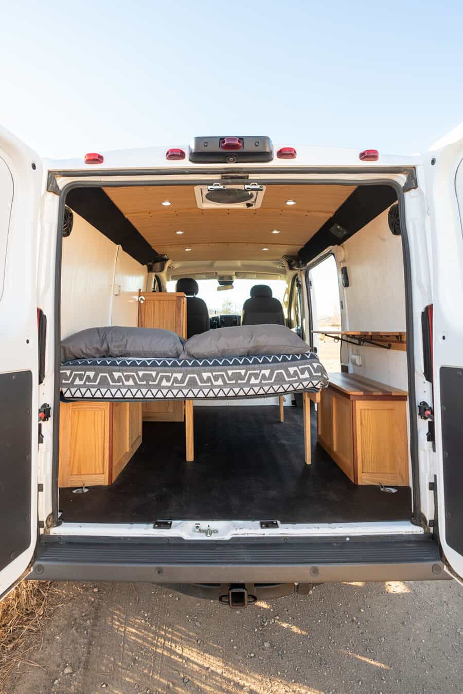 Interior view of a 2018 Ram Promaster 118" camper van showcasing efficient use of space and cozy sle.