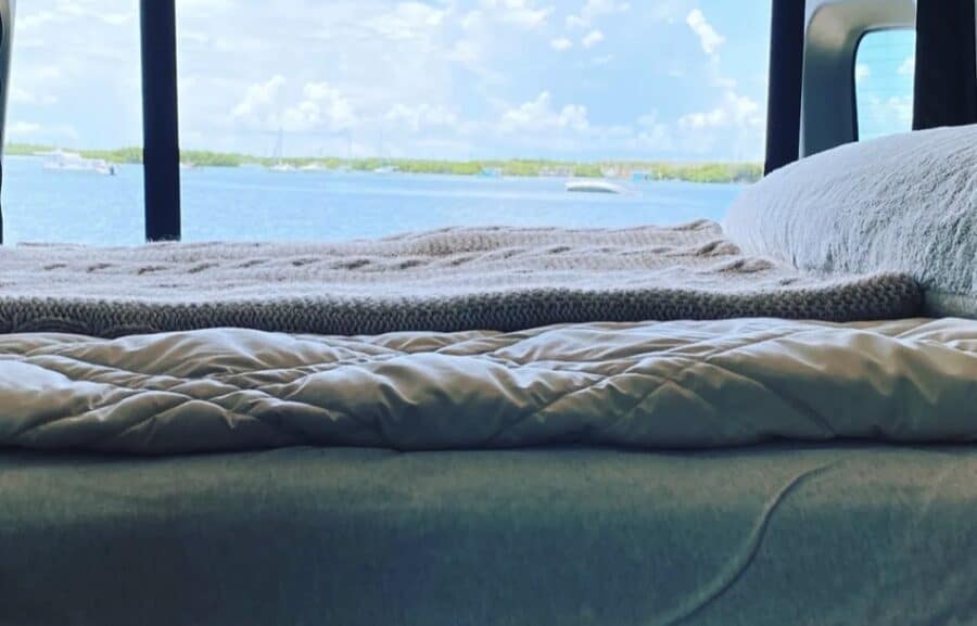 Bright tiny house interior overlooking a scenic water landscape.