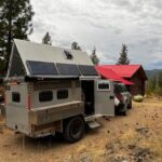 Off-road tiny house with toy hauler features and solar panels.