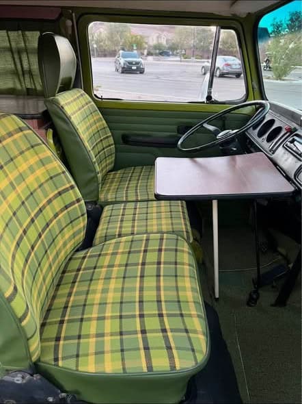 Front seats in green Westfalia plaid with a small folding table