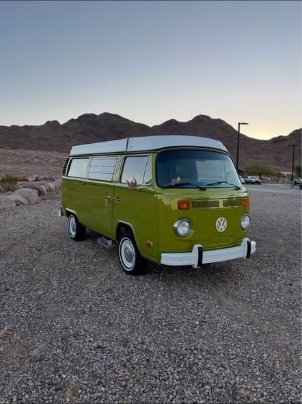 Front of the green VW Westfalia bus in the desert at dusk