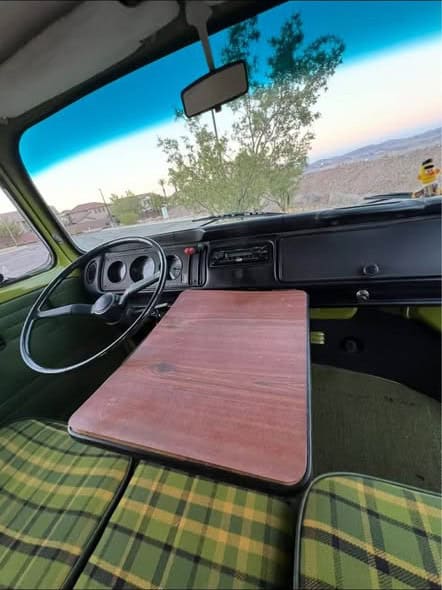 Folding wood table set up in front of the bench, with the dashboard ahead