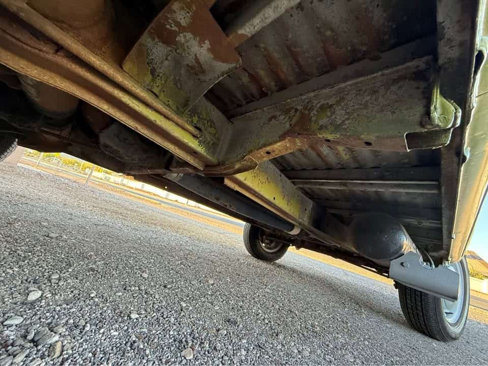 Underside of the bus showing the floor pan and frame rails