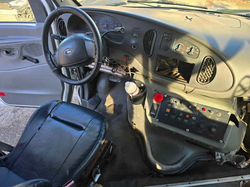 Driver seat, steering wheel, and dashboard with the bus control panel