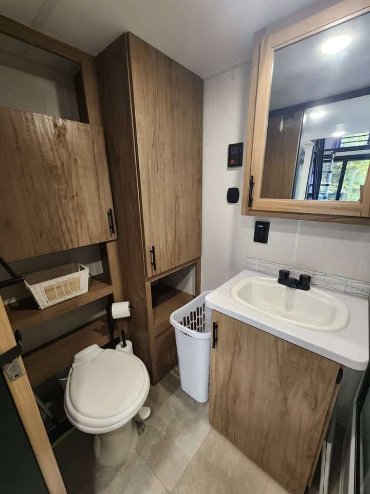 Bathroom toilet, vanity, and tall storage cabinet