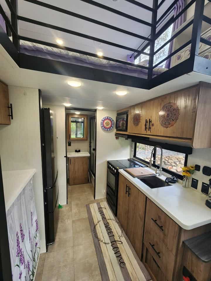 Kitchen under the rear loft, with the bathroom door at the end