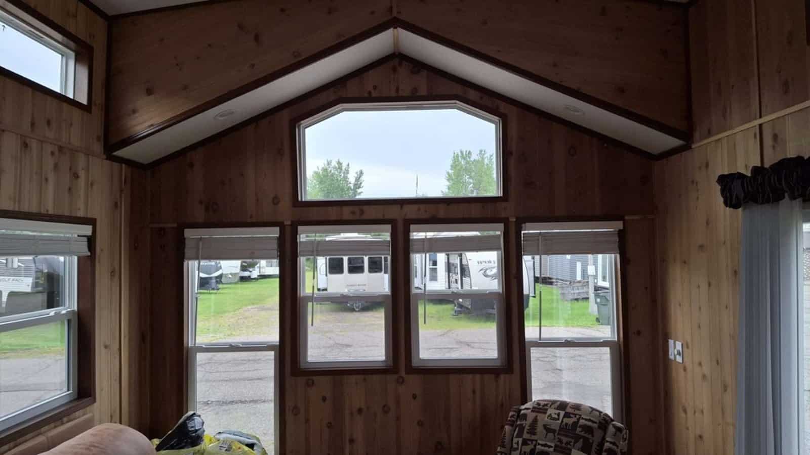 Gable-end wall of windows with an arched transom under the vaulted ceiling
