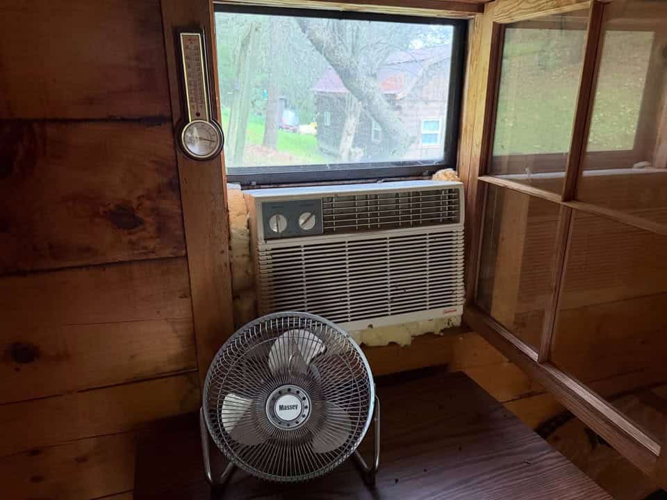 Window air conditioner and a fan below a large window