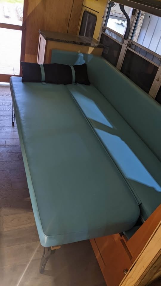 Bench cushions laid flat on the pull-out frame to make a bed