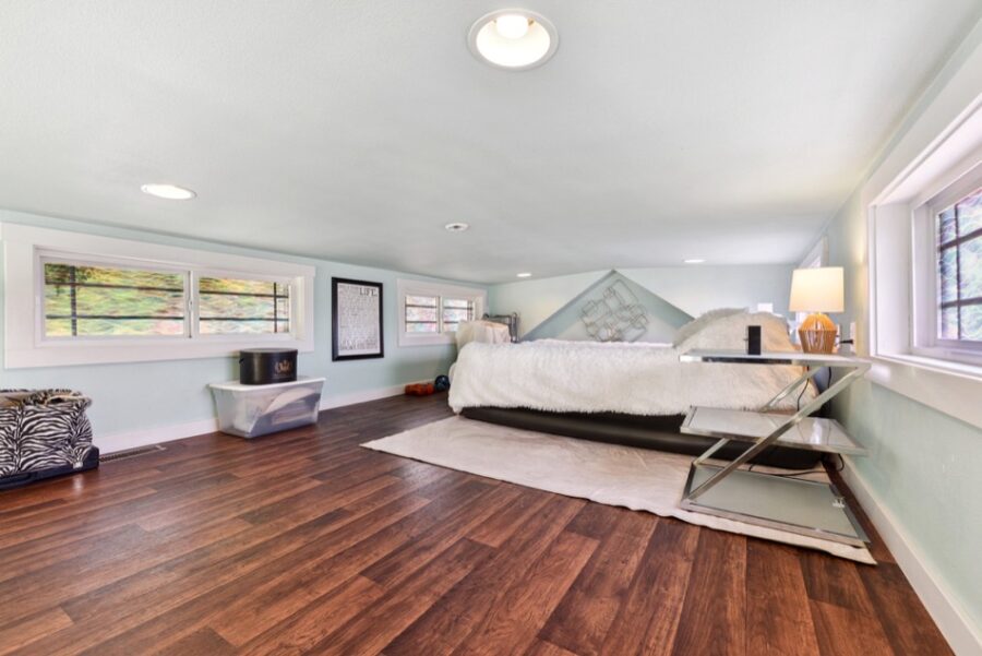Compact tiny house interior with modern decor and large windows for natural light.