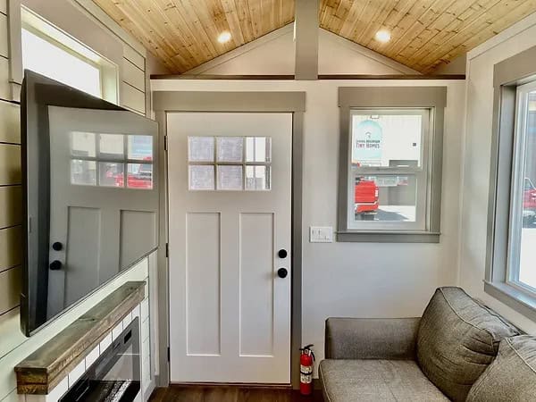 Cozy tiny house interior with modern decor and compact living space.