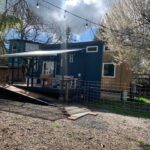 Cozy tiny house in Woodstock, Oregon featuring a spacious deck and lot lease for a small space lifes.
