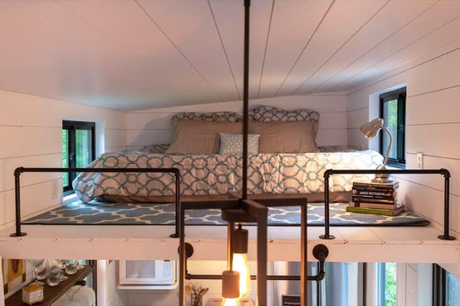 Second sleeping loft with cozy bedding and modern decor