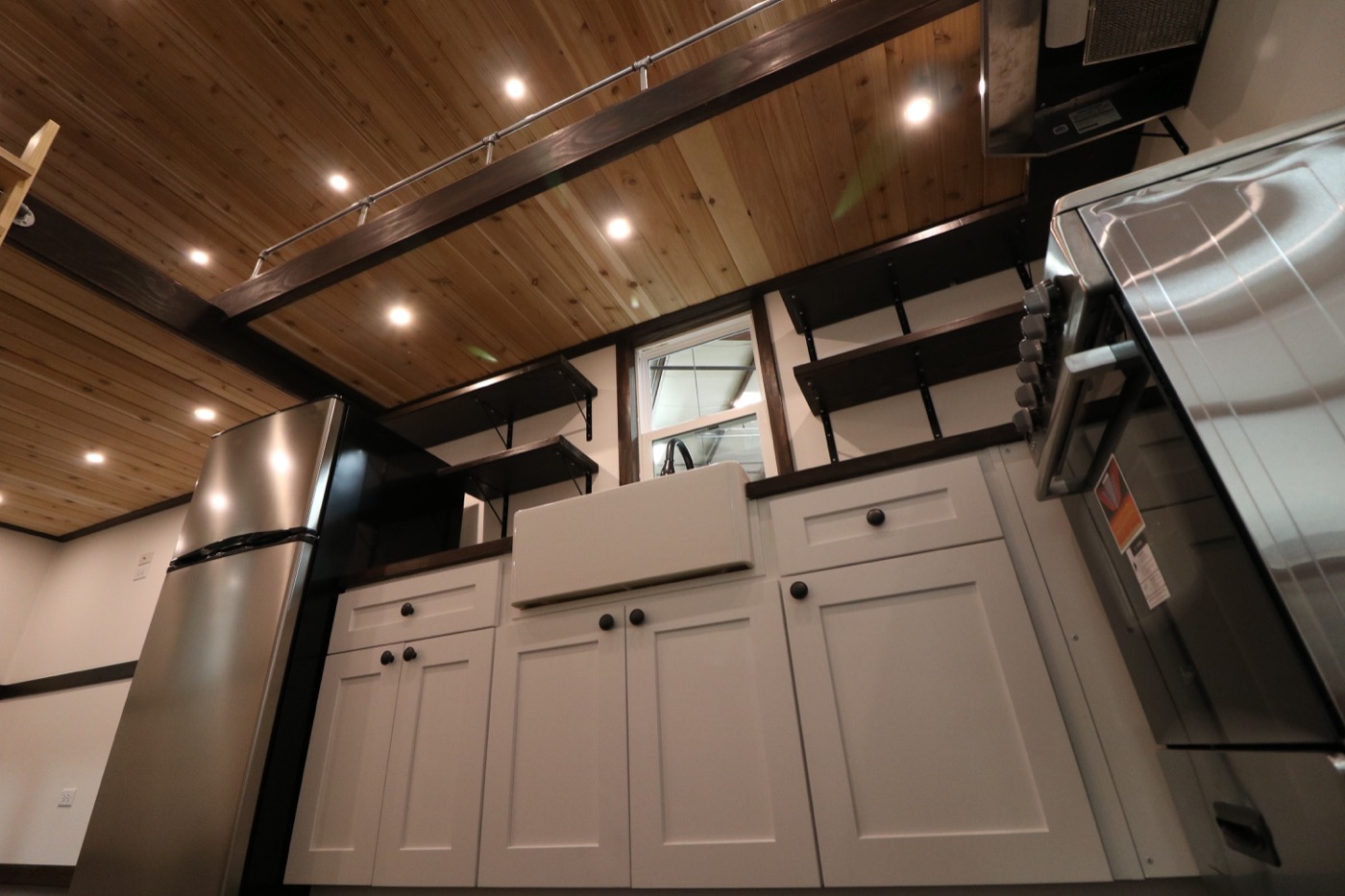 Image showcasing Family of Three’s Off-Grid Tiny House with 12ft Loft-to-Loft Catwalk