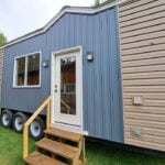 Tiny house with loft and private first-floor bedroom for efficient living.