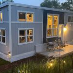 Tiny house with office and outdoor deck for small space living.
