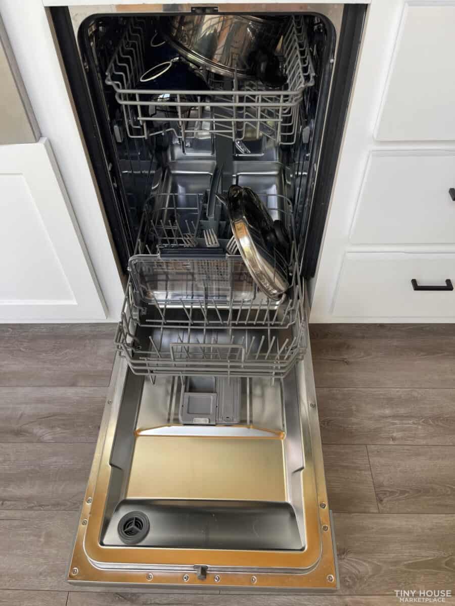 Efficient dishwasher in a compact tiny house kitchen.