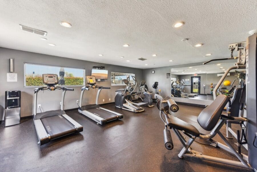 Modern gym inside a tiny house with cardio and strength equipment near Austin.