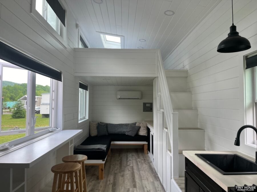 Charming tiny house featuring a screened porch, perfect for small space living in Asheville communit.