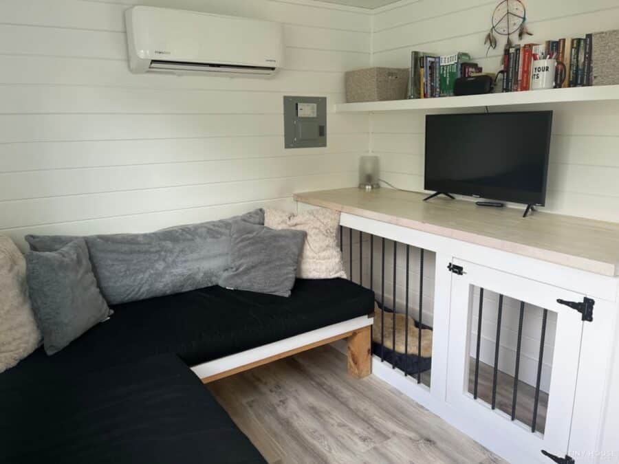 Compact tiny house interior with a comfortable seating area and a screened porch in Asheville commun.