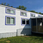Tiny house with screened porch in Asheville community, showcasing modern design and efficient small.