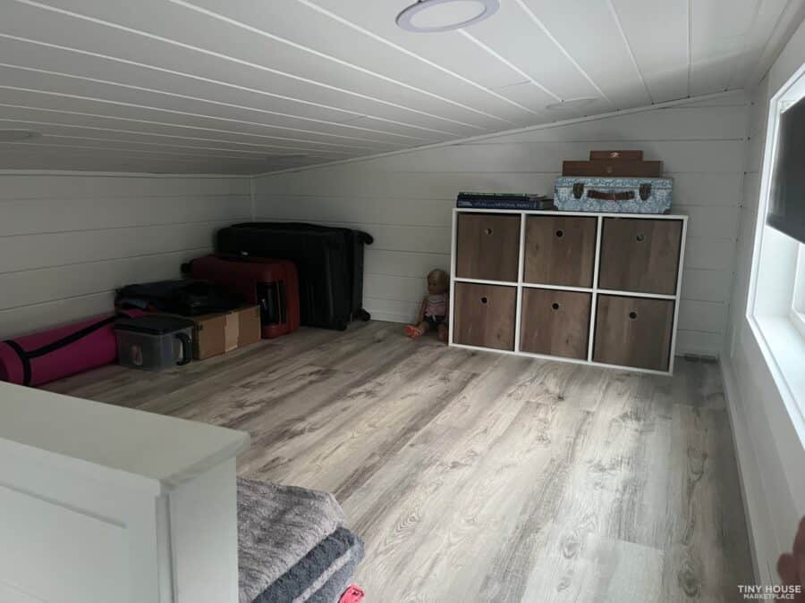 Interior view of a tiny house with a screened porch in Asheville community, showcasing compact livin.