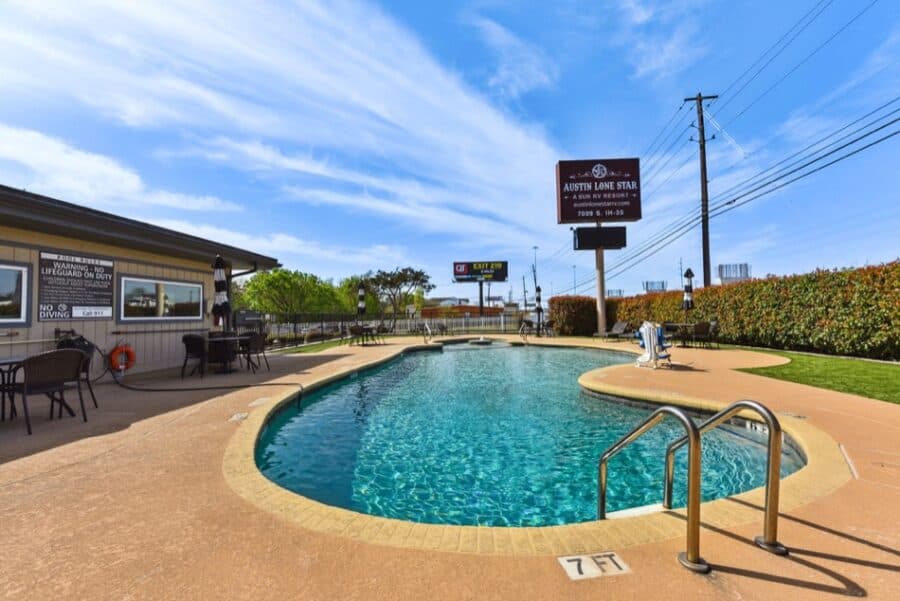 Park model tiny house near Austin at Lone Star RV Resort with pool and outdoor seating.