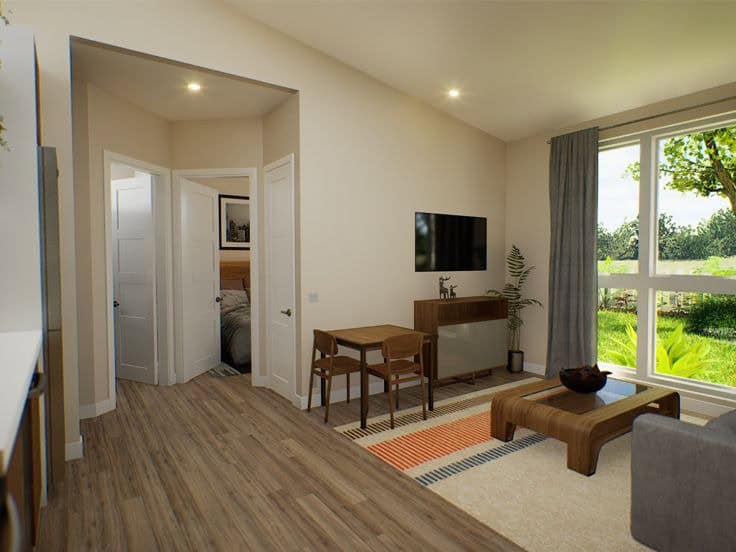 Cozy living room in a 442 sq. ft. tiny house with modern decor and large window views.