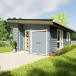 Small modern tiny house with blue siding and a sloped roof in a lush green yard.