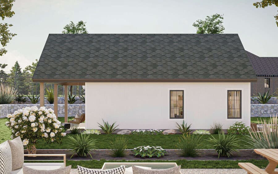 Image shows a modern tiny house with a simple white facade, black roof, and landscaped yard.