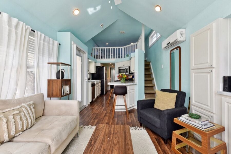 Cozy tiny house interior with open living space and loft at Lone Star RV Resort near Austin.