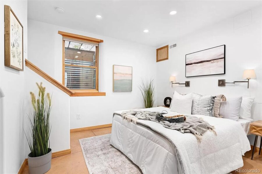 Bright and inviting bedroom with minimalist decor in a 786 sq. ft. Spanish-style house featuring a d.