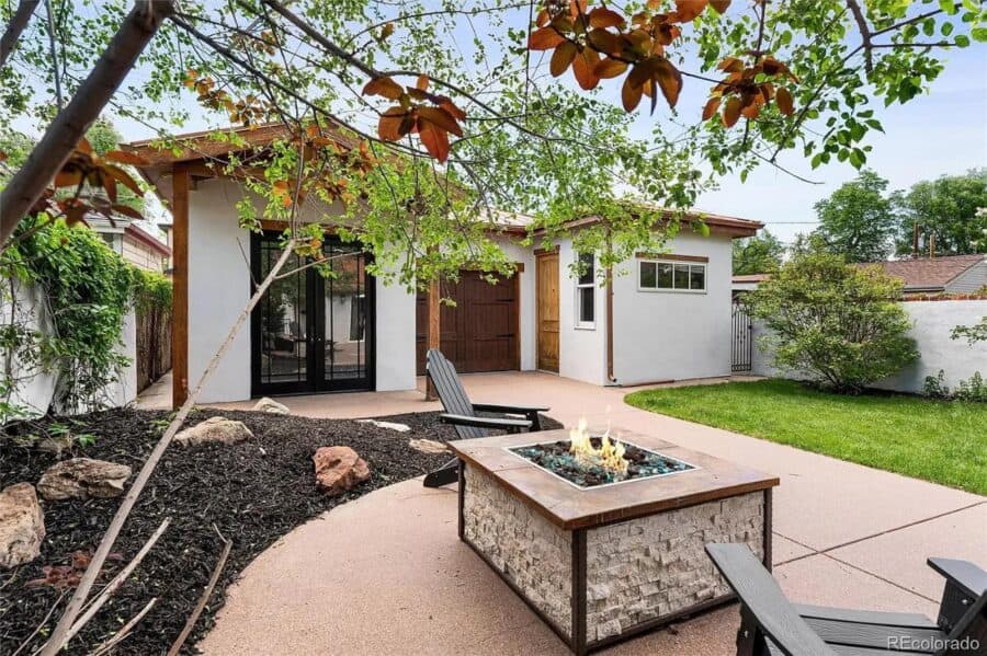 Charming 786 sq. ft. Spanish-style tiny house featuring a detached garage and cozy outdoor patio are.