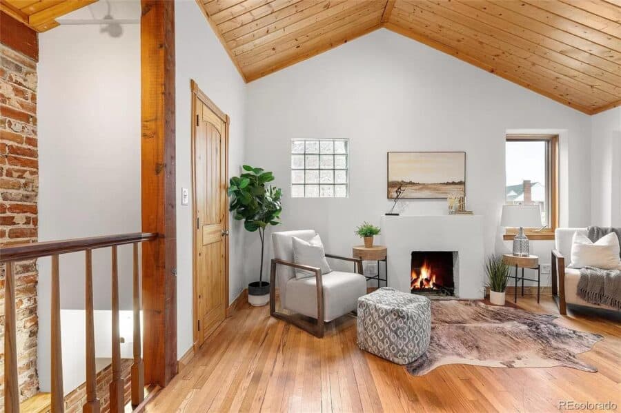 Bright and inviting tiny house living room with vaulted wooden ceiling and modern decor.