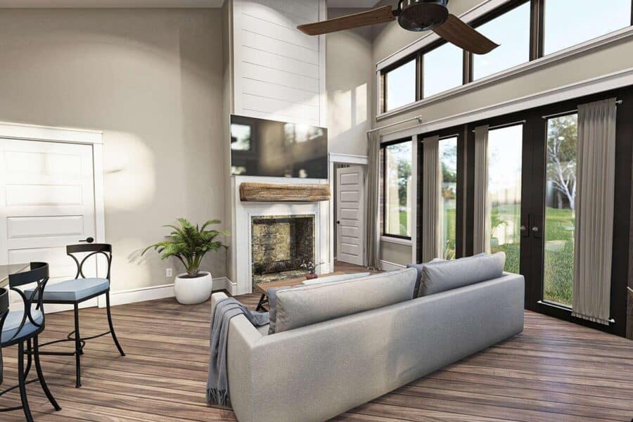 Bright living room with large windows and a dramatic roofline in a small house.