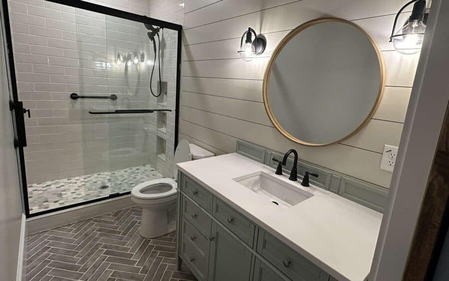 Small bathroom with walk-in shower, white tiles, and modern vanity.